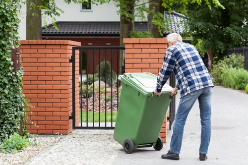 Service technician inspecting a commercial waste bin